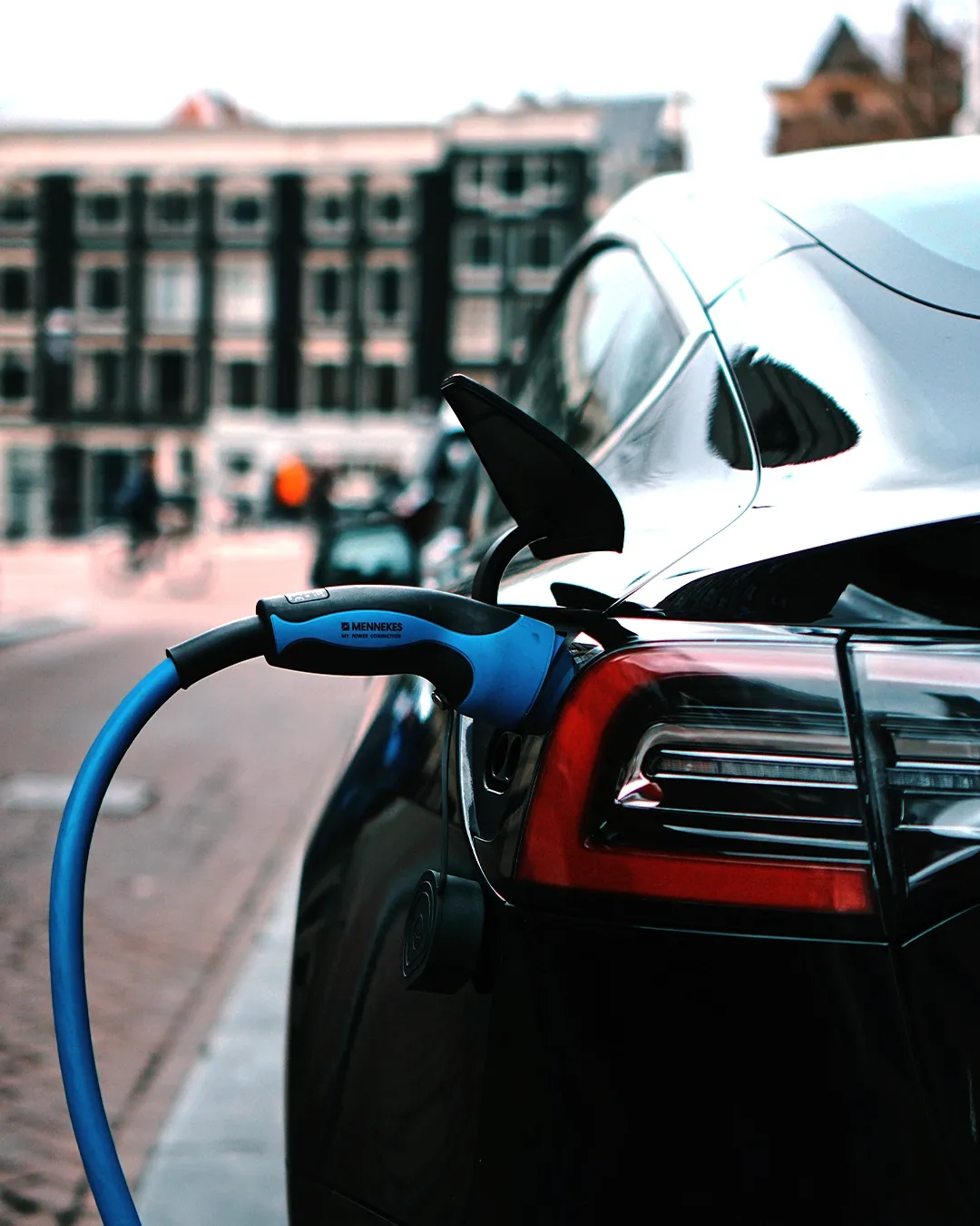 Electric car charging station with an electric vehicle plugged in