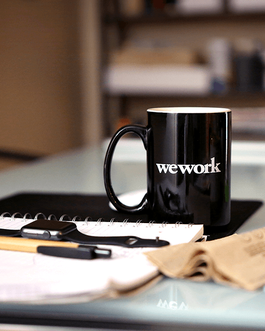 WeWork office space interior with desks and meeting rooms, symbolizing the co-working giant's uncertain future