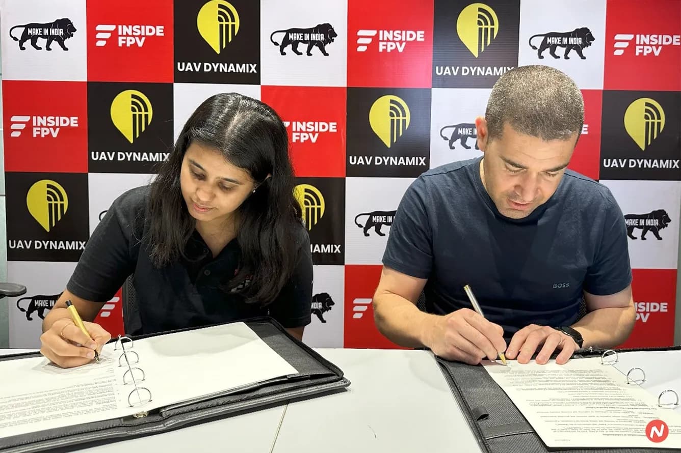 InsideFPV CEO and UAV Dynamix CEO shake hands after signing a strategic MoU for drone technology collaboration and supply.