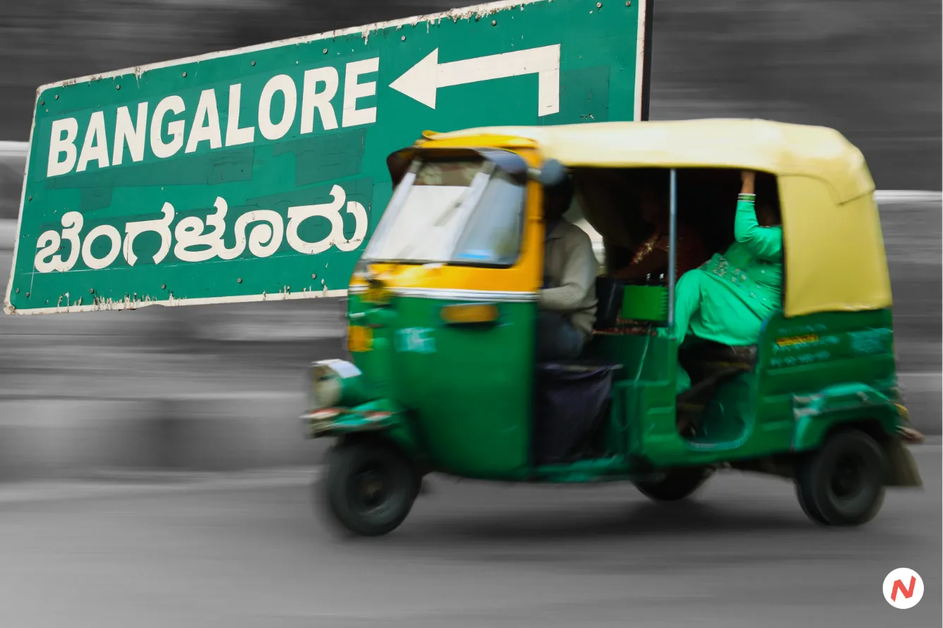 Auto-rickshaws in India, with ride-hailing app logos in the background and a WhatsApp icon prominent