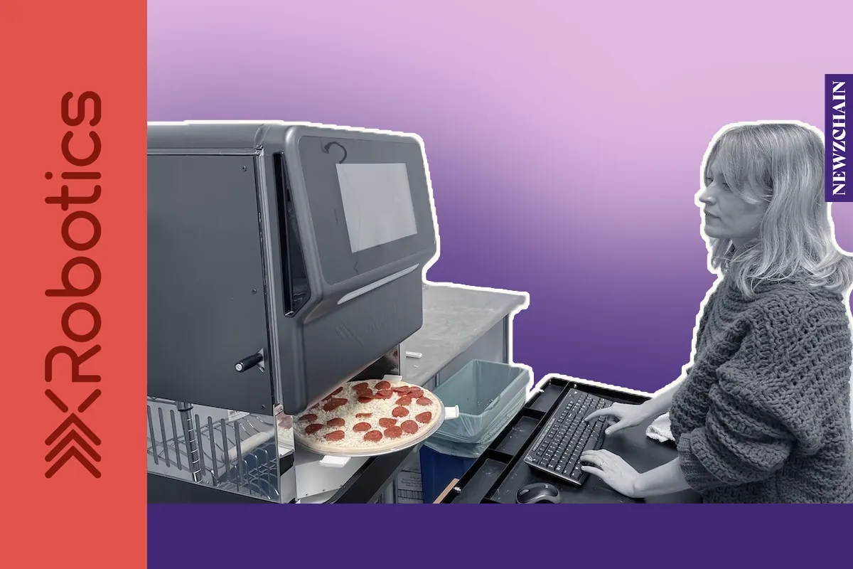 XRobotics' xPizza Cube countertop pizza-making robot, roughly the size of a stackable washing machine, applies sauce and chee